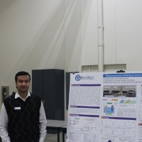 A student standing next to a manufactured metal parts project.